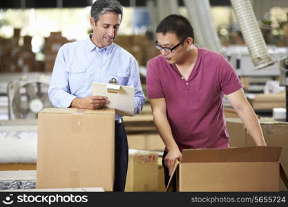 Workers In Warehouse Preparing Goods For Dispatch