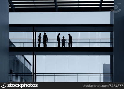 workers inside the modern building in silhouette