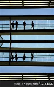 workers inside the modern building in silhouette&#xA;
