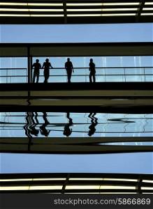 workers inside the modern building in silhouette&#xA;
