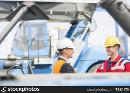 Workers shaking hands in shipping yard