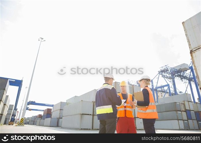 Workers talking in shipping yard