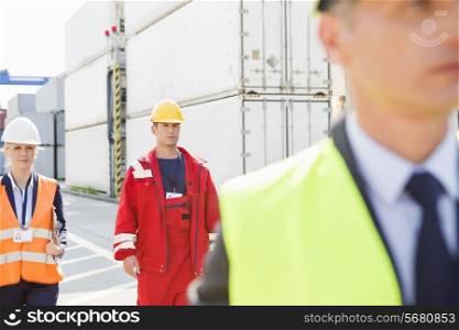 Workers walking in shipping yard
