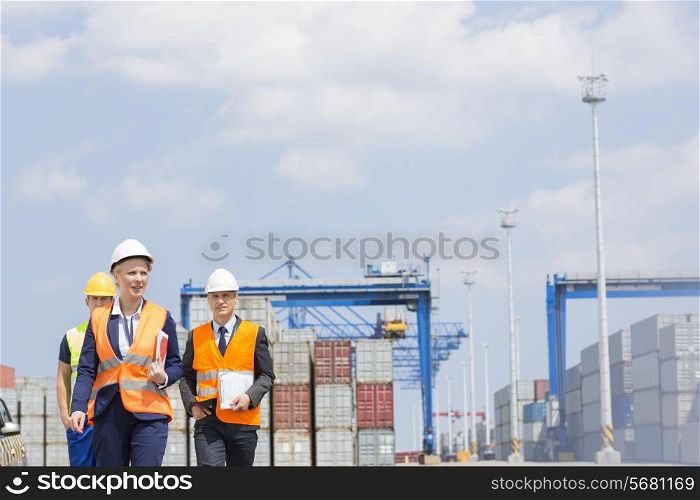 Workers walking in shipping yard