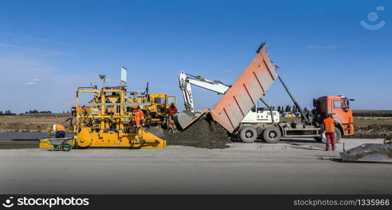 Workers were pouring concrete on road, industrial background