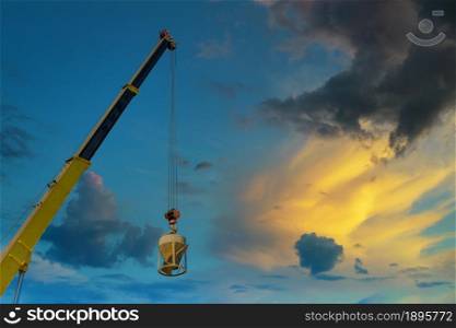 Working at height equipment with bucket liquid concrete container with hanging on crane hook in construction site building industry. Working at height equipment with bucket liquid concrete container with hanging on crane hook