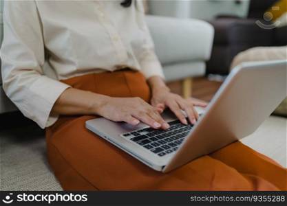 Working by using a laptop computer on wooden table. Hands typing on a keyboard.technology e-commerce concept.