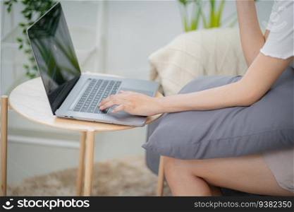 Working by using a laptop computer on wooden table. Hands typing on a keyboard.technology e-commerce 