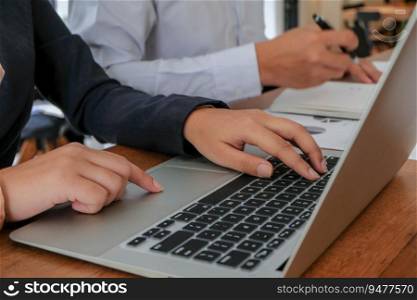 Working by using a laptop computer on wooden table. Hands typing on a keyboard.technology e-commerce

