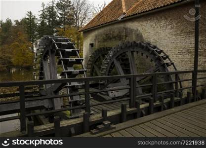 Working Cogwheel driven watermill at Singraven castle in Dinkelland, Netherlands. cogwheel from watermill in holland in nature area singraven