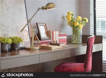 Working desk with reading lamp and red classic chair