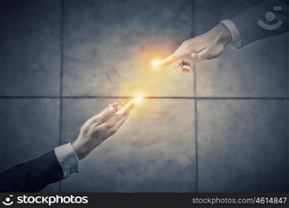 Working in touch. Top view of two businesswpeople reaching fingers to touch each other