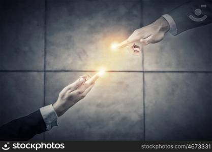 Working in touch. Top view of two businesswpeople reaching fingers to touch each other