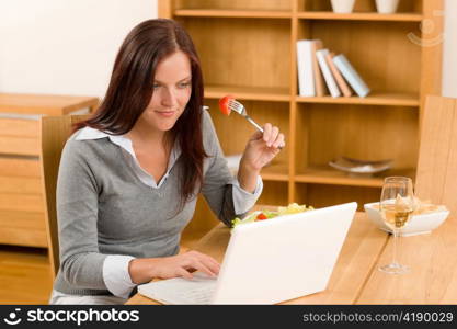 Working lunch at home attractive woman with laptop eat salad