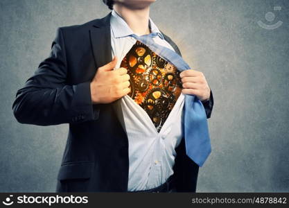 Working mechanism. Close up of businessman acting like superhero