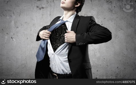 Working mechanism. Close up of businessman acting like superhero