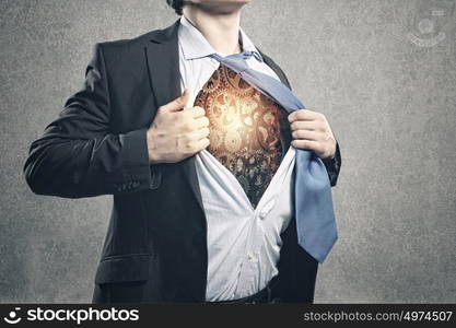 Working mechanism. Close up of businessman acting like superhero