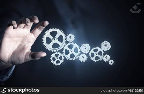 Working mechanism for business. Hand of businesswoman and gear mechanism as teamwork concept