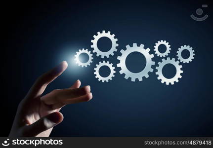 Working mechanism for business. Hand of businesswoman and gear mechanism as teamwork concept