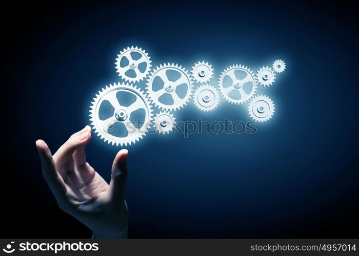 Working mechanism for business. Hand of businesswoman and gear mechanism as teamwork concept