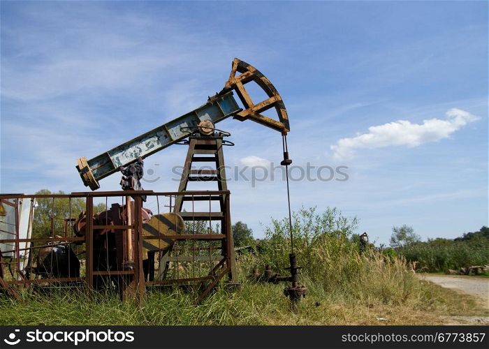 Working oil pump on the background blue sky