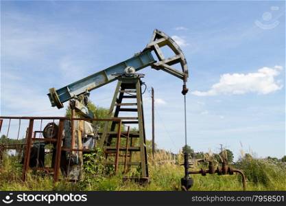 Working oil pump on the background blue sky