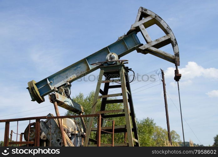 Working oil pump on the background blue sky