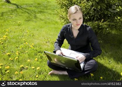 Working Outdoors. Young Woman Working On Laptop.
