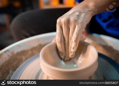 Working process of man&rsquo;s work at potters wheel in art studio. Unknown craftsman creates jug. Focus on hands only. Small business, talent, invention, inspiration concept.. Working process of man&rsquo;s work at potters wheel in art studio. Unknown craftsman creates jug. Focus on hands only. Small business, talent, invention, inspiration concept