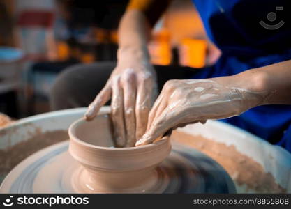 Working process of man’s work at potters wheel in art studio. Unknown craftsman creates jug. Focus on hands only. Small business, talent, invention, inspiration concept.. Working process of man’s work at potters wheel in art studio. Unknown craftsman creates jug. Focus on hands only. Small business, talent, invention, inspiration concept