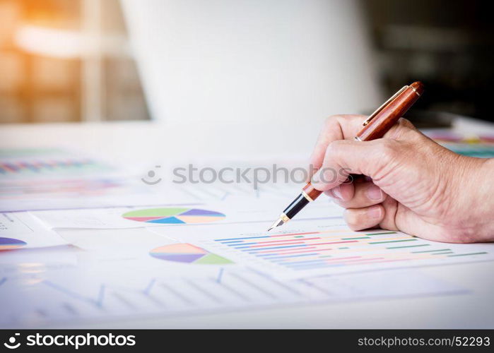 Working process startup. Businessman working at the wood table with new finance project. Modern notebook on table. Pen holding hand