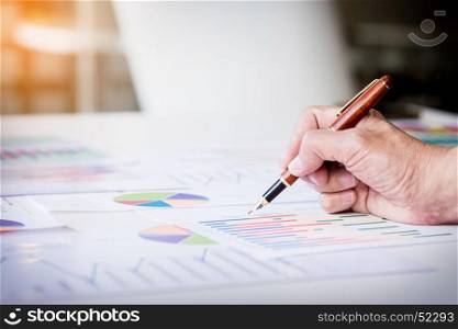Working process startup. Businessman working at the wood table with new finance project. Modern notebook on table. Pen holding hand