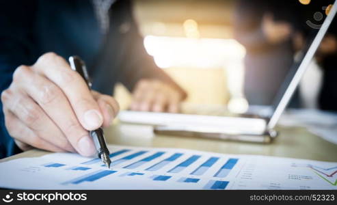 Working process startup. Businessman working at the wood table with new finance project. Modern notebook on table. Pen holding hand.