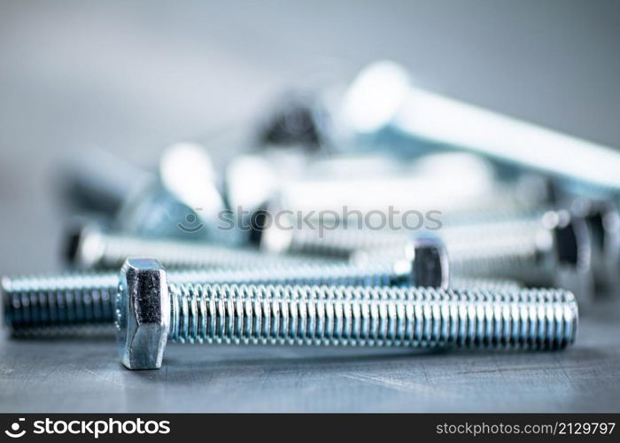 Working tool. Bolts on a gray background. High quality photo. Working tool. Bolts on a gray background.