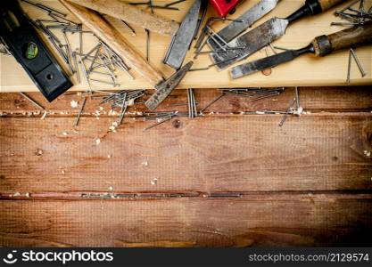 Working tool. Chisel, hammer and nails. On a wooden background. High quality photo. Working tool. Chisel, hammer and nails.