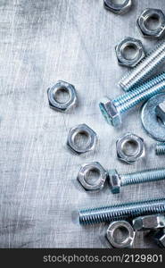 Working tool. Nuts and bolts on the table. On a gray background. High quality photo. Working tool. Nuts and bolts on the table.