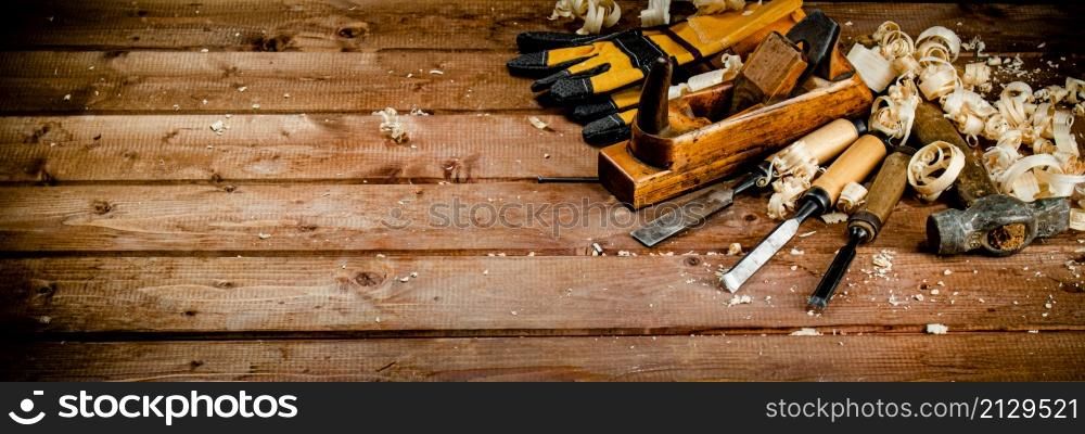 Working tool on wood with sawdust. On a wooden background. High quality photo. Working tool on wood with sawdust.