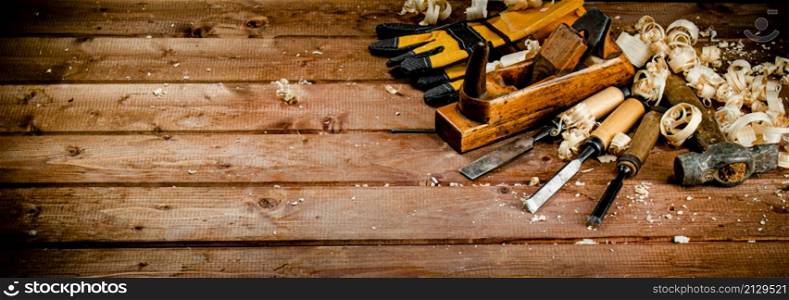 Working tool on wood with sawdust. On a wooden background. High quality photo. Working tool on wood with sawdust.