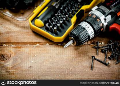 Working tools. Screwdriver bits. On a wooden background. High quality photo. Working tools. Screwdriver bits. On a wooden background.