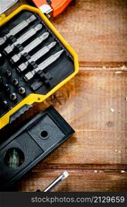 Working tools. Screwdriver bits. On a wooden background. High quality photo. Working tools. Screwdriver bits. On a wooden background.