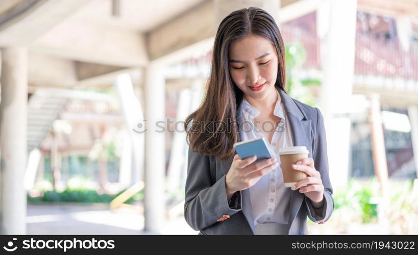 Working woman concept a young female manager attending video conference and holding a cup of coffee.