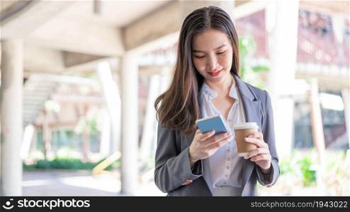 Working woman concept a young female manager attending video conference and holding a cup of coffee.
