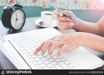 Working woman using laptop computer and holding credit card, Online shopping