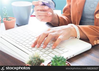 Working woman using laptop computer and holding credit card, Online shopping