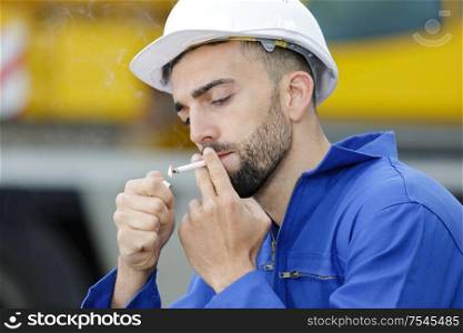 workman having a break and smoking a cigarette