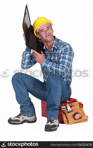 Workman listening to his laptop