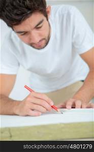 Workman marking material with pencil