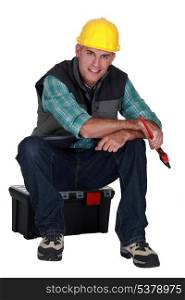 Workman sitting on a toolbox