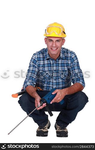 Workman with a masonry drill