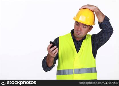 workman with fluorescent safety jacket looks puzzled